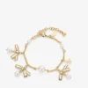 Bracciale con nastri e ciondoli multipli Bracciale in metallo dorato con ciondoli, nastri e perle Bracciale con nastri e ciondoli multipli Bracciale in metallo dorato con ciondoli, nastri e perle