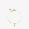 Bracciale Jc Pearl Cube in metallo dorato con perla e cubo di cristallo Bracciale Jc Pearl Cube in metallo dorato con perla e cubo di cristallo