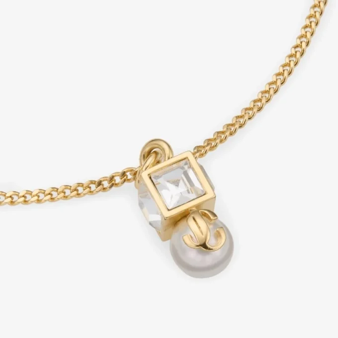 Bracciale Jc Pearl Cube in metallo dorato con perla e cubo di cristallo Bracciale Jc Pearl Cube in metallo dorato con perla e cubo di cristallo