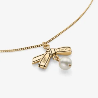 Collana con ciondolo a nastro Collana con ciondolo in metallo dorato con nastro e perla