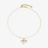 Collana con ciondolo a nastro Collana con ciondolo in metallo dorato con nastro e perla
