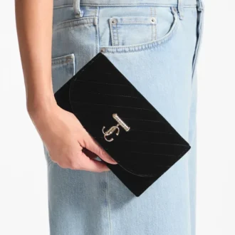 Portafoglio Curve con catena Mini borsa in velluto trapuntato nero con barra JC in cristallo